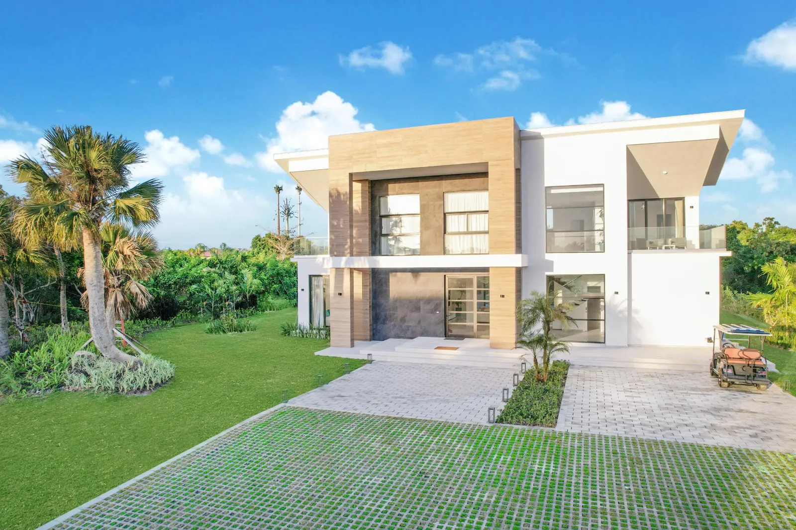 The front of the house among the palms
