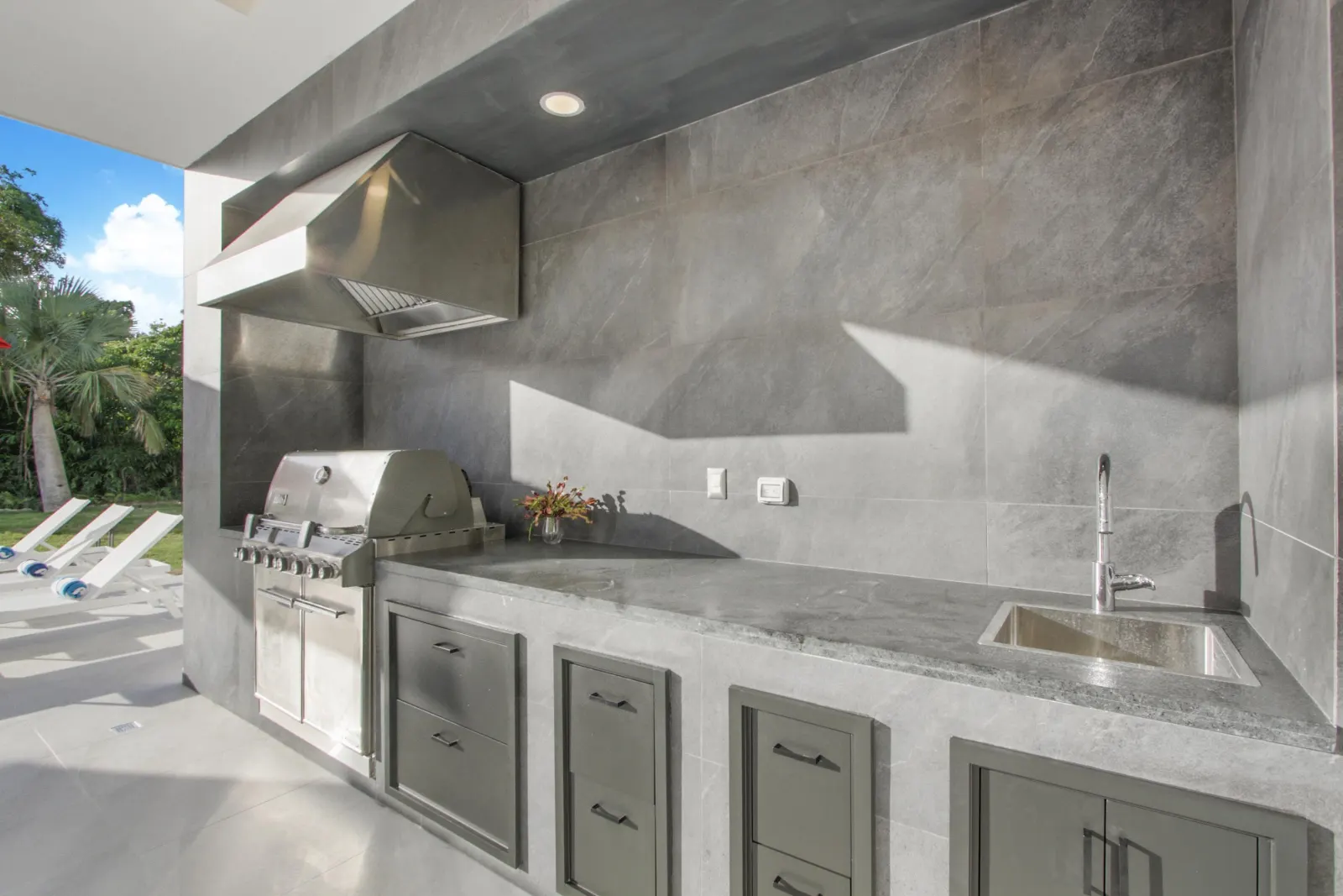 An outdoor kitchen in grey stone