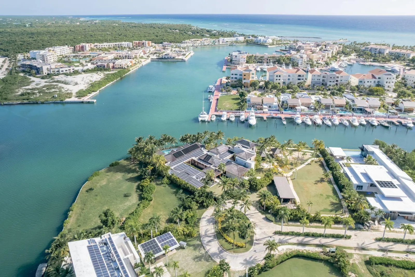 The Marina of Cap Cana from the air, the private island and its house in the foreground