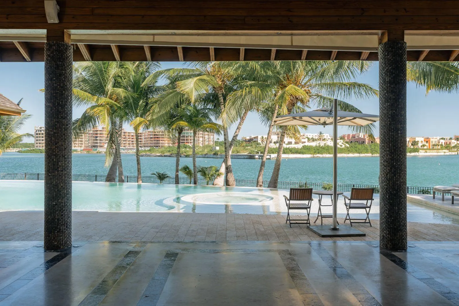 A shaded terrace looking across the pool to the Marina