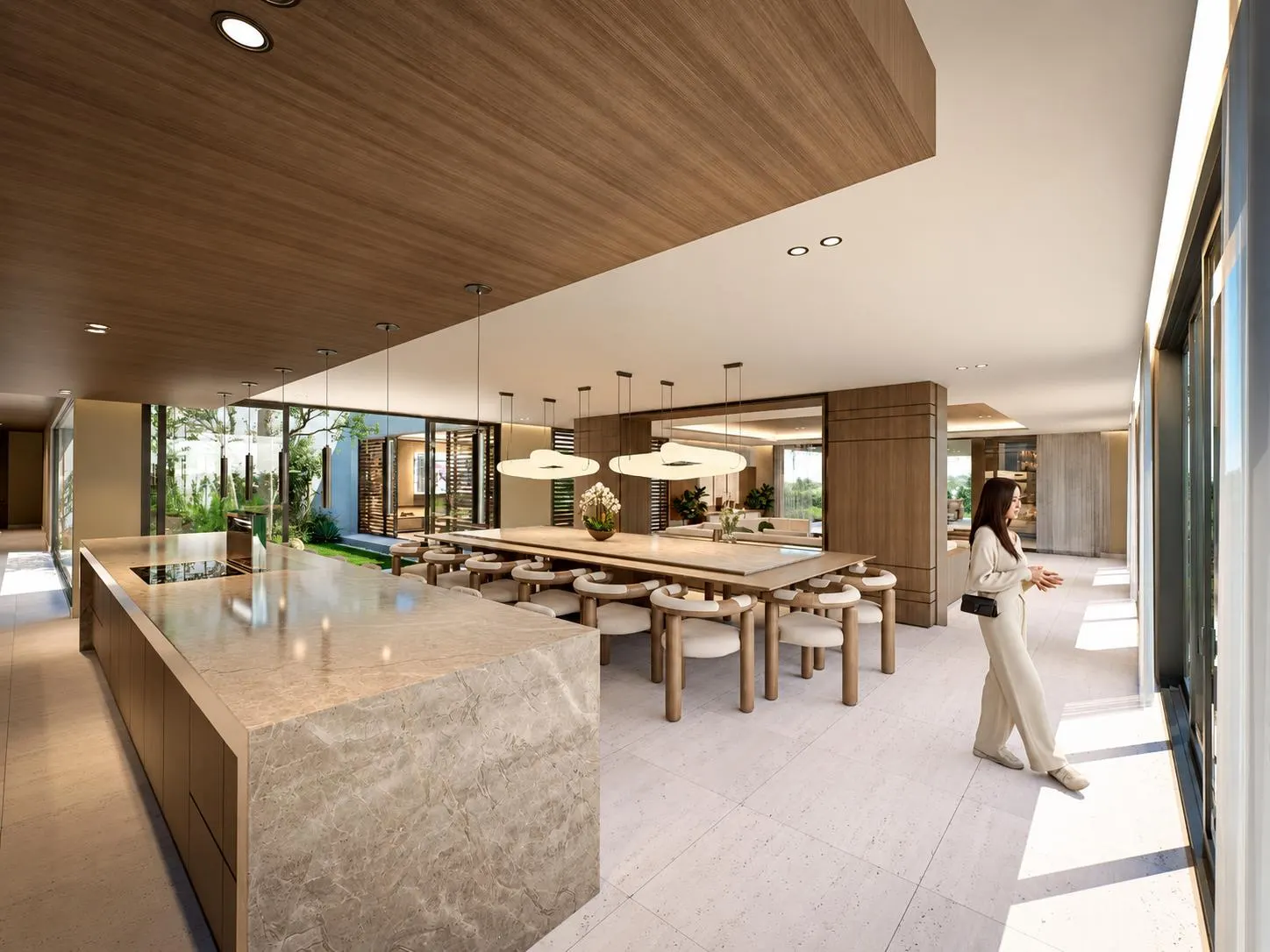 An open kitchen with a stone island and a long dining table