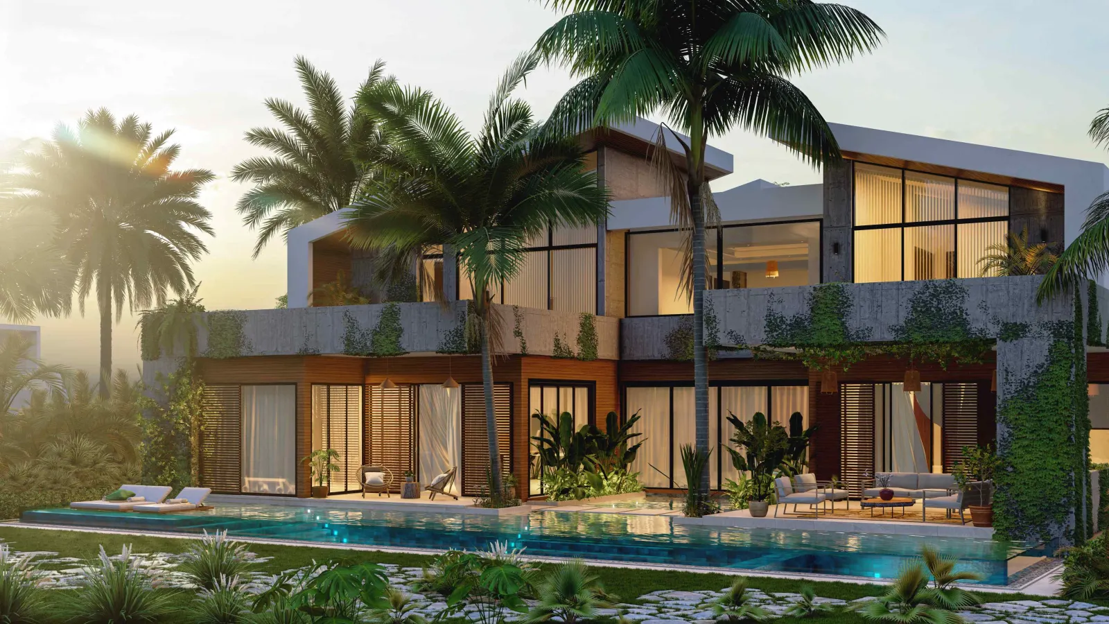 The house in the low sun behind its pool, lit from within