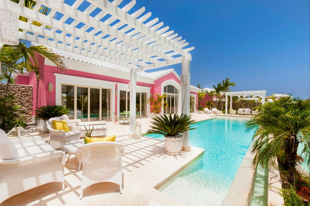 A villa at Eden Roc: a pool, a white pergola and a terrace in the sun