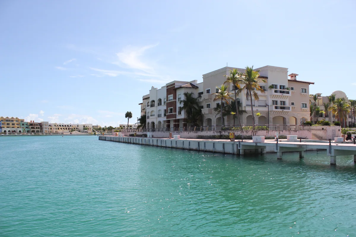 Residences along the quay of the Marina of Cap Cana, the water turquoise in front
